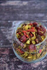 Homemade matcha granola in glass on wooden background