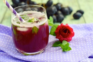 Grape mint soda mocktail with fresh grapes background