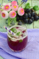 Grape mint soda mocktail with fresh grapes background