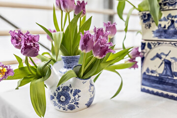 Purple tulips in a vase in the garden. Spring. Bloom.