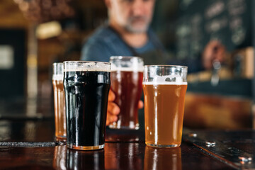 bartender working in bar. he is pouring beer