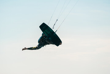 Kiteboard or kitesurfing tricks. Summer sport learning how to kitesurf. Kite surfing on Puck bay in...