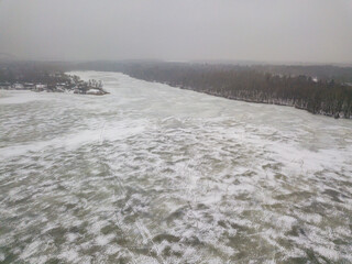 Frosty patterns on ice. Aerial drone view. Foggy winter morning.