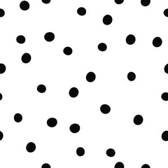 Black polka dots on white background. Seamless doodle pattern with random dots.