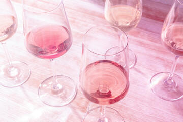 Glasses of rose wine, toned in pink, a party