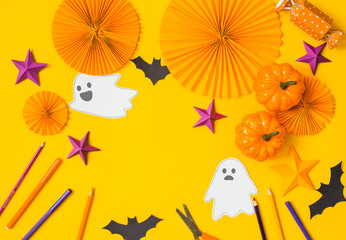 Halloween paper craft flat lay.Children seasonal art table top view.Kids hand craft concept.Bright halloween background with cutted out ghosts and paper crafts.