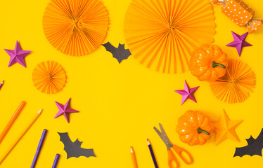 Halloween paper orange and purple craft flat lay.Children seasonal art table top view.Kids hand craft concept.Bright halloween background.