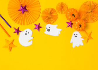 Halloween paper craft flat lay.Children seasonal art table top view.Kids hand craft concept.Bright halloween background with cutted out ghosts and paper crafts.