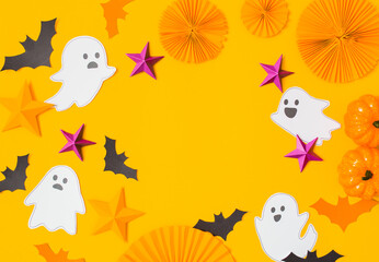 Halloween paper craft flat lay.Children seasonal art table top view.Kids hand craft concept.Bright halloween background with cutted out ghosts and paper crafts.