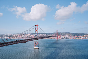 Beautiful landscape with suspension 25 April bridge bridge over the Tagus river in Lisbon, Portugal.