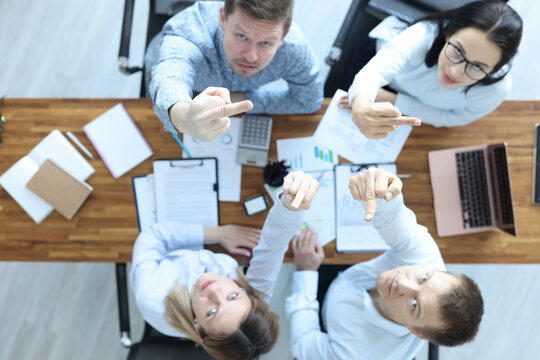 Furious businessmen look up and show the facts