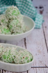 Indonesian Cuisine, Klepon or Traditional Pandanus Rice Balls Made From Glutinous Flour and Grated Coconut with Palm sugar Filling