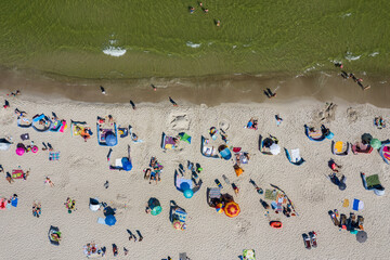 Sunbathing on the beach by the sea. Aerial drone view of  Baltic Sea coast in Hel peninsula, Jastarnia. Puck Bay in Poland