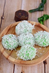 Indonesian Cuisine, Klepon or Traditional Pandanus Rice Balls Made From Glutinous Flour and Grated Coconut with Palm sugar Filling