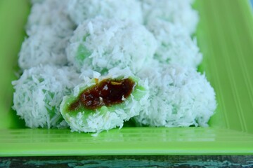 Indonesian Cuisine, Klepon or Traditional Pandanus Rice Balls Made From Glutinous Flour and Grated Coconut with Palm sugar Filling