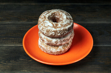 Homemade round gingerbread cookies with icing in a orange plate. Idea for a delicious breakfast or dinner. Top view