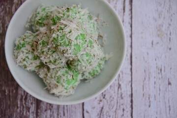 Indonesian Cuisine, Klepon or Traditional Pandanus Rice Balls Made From Glutinous Flour and Grated Coconut with Palm sugar Filling