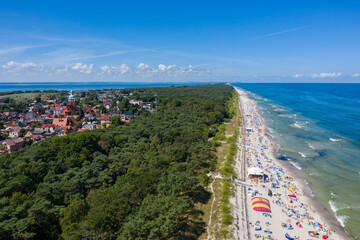 Sunbathing on the beach by the sea. Aerial drone view of  Baltic Sea coast in Hel peninsula, Jastarnia. Puck Bay in Poland - obrazy, fototapety, plakaty