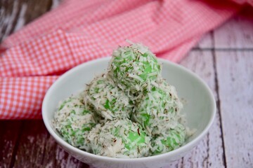 Indonesian Cuisine, Klepon or Traditional Pandanus Rice Balls Made From Glutinous Flour and Grated Coconut with Palm sugar Filling