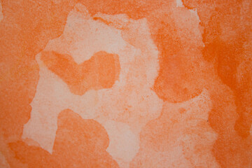 Orange watercolor background. Watercolor splash on paper in the form of abstraction. Orange gradient handmade