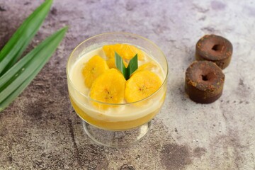 Indonesian Cuisine - Kolak Pisang or Plantain Banana Compote. Cooked with coconut milk, palm sugar and pandanus leaves. Ramadhan menu.