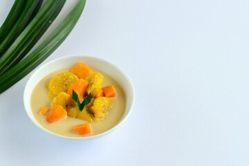 Indonesian Food, Kolak Pisang Ubi or Banana Sweet Potato Compote. Made from Plantain Banana cooked with coconut milk, palm sugar and pandanus leaves. Popular dessert during Ramadan