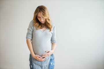 Portrait of young pregnant woman at home.