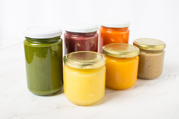 Variety of homemade baby vegetable and fruit puree