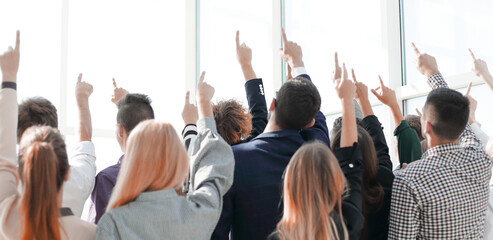 Fototapeta premium group of diverse young people pointing to a copy of the space