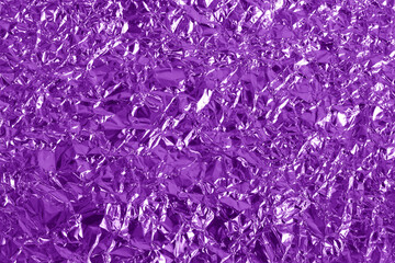 Purple metallic foil shiny texture, wrinkled wrapping paper for background and design art work.