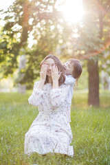Obraz premium Happy young mother with daughter outdoors.