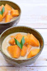 Kolak ubi - Indonesian dessert. Sweet potato cooked in coconut milk, palm sugar and pandan leaves