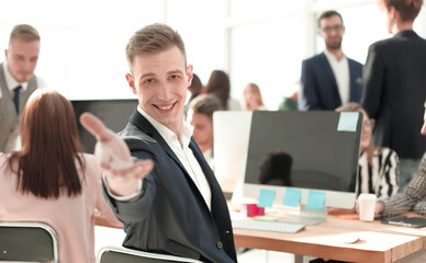 friendly young businessman sitting at his Desk