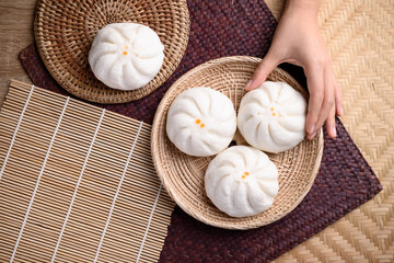 Steamed buns stuffed with minced pork holding by hand, Asian food