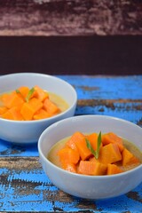 Kolak ubi - Indonesian dessert. Sweet potato cooked in coconut milk, palm sugar and pandan leaves