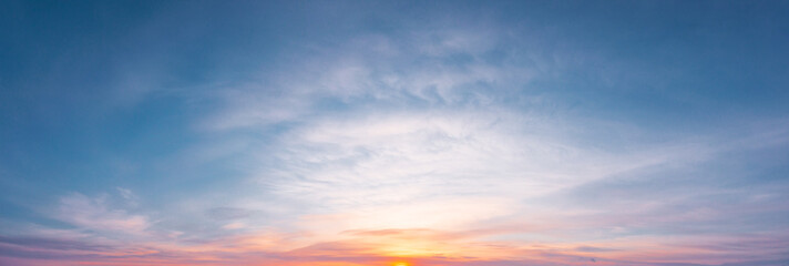 Obraz premium panoramic sunrise with cirrus clouds illuminated by the rays of the sun
