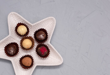 Chocolate cheese truffles, homemade chocolate. Delicious chocolate candies. Group of sweet chocolate truffles on gray background. Selective focus