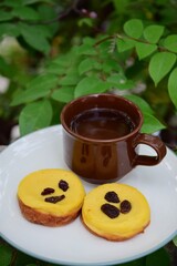 Kue Lumpur, Indonesian cuisine, made from potato, egg, coconut milk, butter, flour and sugar garnish with raisin. Served with cup of tea. Snack for breaking the fast or buka puasa