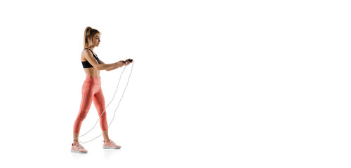 Flyer. Young caucasian female model in action, motion isolated on white background with copyspace. Concept of sport, movement, energy and dynamic, healthy lifestyle. Training, practicing.