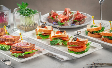 Set of appetizers, bruschetta and sandwiches at the catering service