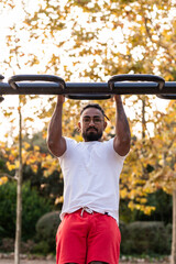 african american athlete doing fitness exercises on bars, calisthenics workout.