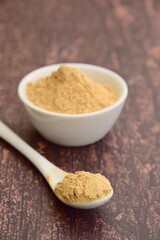 Maca powder on wooden background, selective focus