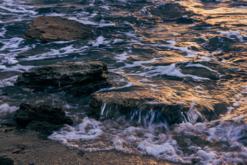 Blurred abstract natural background of sea water with waves and foam. Motion blur. Nature. 
