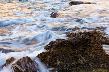 Blurred abstract natural background of sea water with waves and foam. Motion blur. Nature. 