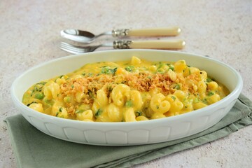 Creamy baked cavatappi pasta with sweet potato, cheddar cheese, peas and spinach garnish with panko crumbs