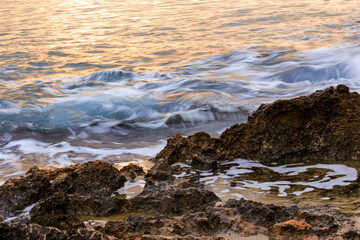 Blurred abstract natural background of sea water with waves and foam. Motion blur. Nature. 
