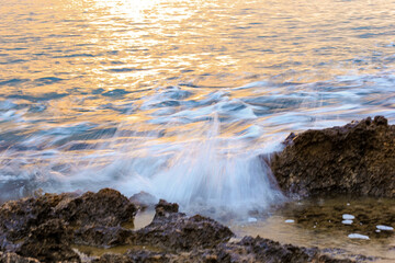 Blurred abstract natural background of sea water with waves and foam. Motion blur. Nature. 