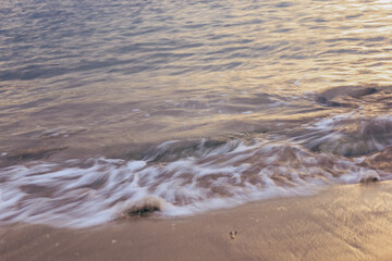 Blurred abstract natural background of sea water with waves and foam. Motion blur. Nature. 