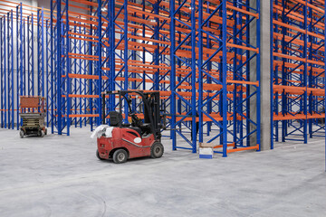 steel shelves rack in new modern large warehouse. loader next to the racks. nobody. no people.