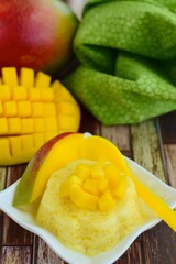 Mango pudding with cubed fresh mango on top